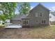 Backyard view showcasing the home's gray siding and a spacious deck, great for entertaining or relaxing outdoors at 1359 Chatley Way, Woodstock, GA 30188