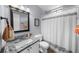 Functional bathroom features a granite countertop, a toilet, and a shower with a curtain at 1359 Chatley Way, Woodstock, GA 30188