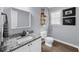 Well-lit bathroom with a granite countertop, framed mirror, and modern fixtures at 1359 Chatley Way, Woodstock, GA 30188