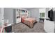 A neutrally painted bedroom featuring built-in shelving and lots of natural light at 1359 Chatley Way, Woodstock, GA 30188