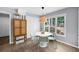 Bright dining area with a modern light fixture and lots of natural light from the large window at 1359 Chatley Way, Woodstock, GA 30188