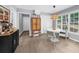 Open dining area with a rattan pendant light, seating for four, and a wooden cabinet at 1359 Chatley Way, Woodstock, GA 30188