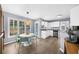 Kitchen and dining area with white cabinetry, granite countertops, and stainless steel appliances at 1359 Chatley Way, Woodstock, GA 30188