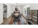Dining room with modern black table, stylish chairs, and view into the adjacent kitchen at 1359 Chatley Way, Woodstock, GA 30188