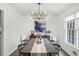 Tasteful dining room features a modern chandelier, table and chairs, ideal for entertaining at 1359 Chatley Way, Woodstock, GA 30188