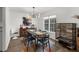 Well-lit dining room with large window, modern table and chairs, offering a comfortable dining space at 1359 Chatley Way, Woodstock, GA 30188