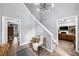 Inviting foyer with staircase, stylish light fixture, and views into other rooms, offering a warm welcome at 1359 Chatley Way, Woodstock, GA 30188