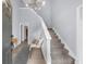 Inviting foyer with staircase, stylish light fixture, and views into other rooms, offering a warm welcome at 1359 Chatley Way, Woodstock, GA 30188