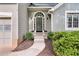 Elegant front entry with an arched window above the door, complemented by well-maintained landscaping at 1359 Chatley Way, Woodstock, GA 30188