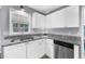 Well-lit kitchen area with white cabinets and granite countertops, offering a clean, modern look at 1359 Chatley Way, Woodstock, GA 30188