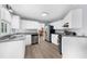 Bright kitchen with white cabinets, granite countertops, and stainless steel appliances, perfect for cooking at 1359 Chatley Way, Woodstock, GA 30188