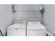 Convenient laundry room area with washer, dryer, and shelving for storage at 1359 Chatley Way, Woodstock, GA 30188