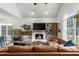 Cozy living room with a fireplace, large windows, and stylish furniture arrangement creates a comfortable gathering space at 1359 Chatley Way, Woodstock, GA 30188