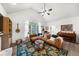 Cozy living room with vaulted ceiling, a large brown leather sofa, and an eye-catching decorative rug at 1359 Chatley Way, Woodstock, GA 30188