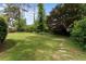 Picturesque backyard with lush green grass and mature trees, providing a serene outdoor space at 3802 Birchbriar Ct, Decatur, GA 30034