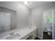 Bright bathroom with dual vanity, neutral color palette, and tiled floor detail at 3802 Birchbriar Ct, Decatur, GA 30034