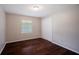 Bright bedroom featuring hardwood floors, neutral paint, and a window with backyard view at 3802 Birchbriar Ct, Decatur, GA 30034