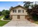 Front exterior of home featuring a two-car garage and brick accents at 3802 Birchbriar Ct, Decatur, GA 30034