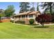 A ranch-style home with a brick foundation, covered porch, and well-manicured lawn and landscaping at 3802 Birchbriar Ct, Decatur, GA 30034