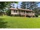 Traditional ranch-style home with a brick foundation, covered porch, and a spacious, green lawn at 3802 Birchbriar Ct, Decatur, GA 30034