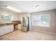 Bright eat-in kitchen features stainless steel appliances, white cabinetry and great natural light at 3802 Birchbriar Ct, Decatur, GA 30034