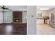 Open-concept space with a fireplace, dark hardwood floors, kitchen with stainless steel appliances at 3802 Birchbriar Ct, Decatur, GA 30034