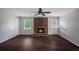 Cozy living room featuring a brick fireplace, dark hardwood floors, and neutral paint at 3802 Birchbriar Ct, Decatur, GA 30034