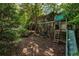 A charming playhouse and swing set nestled in a lush, green backyard at 4243 Mcclatchey Ne Cir, Atlanta, GA 30342
