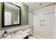 Stylish bathroom with white subway tiles, marble countertops, and a black framed mirror at 4243 Mcclatchey Ne Cir, Atlanta, GA 30342