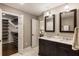 Bathroom with double vanity, marble countertop, and walk-in closet with custom shelving at 4243 Mcclatchey Ne Cir, Atlanta, GA 30342