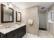 Bathroom with double vanity, marble countertop, walk-in shower, and white subway tile at 4243 Mcclatchey Ne Cir, Atlanta, GA 30342