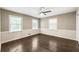 Bright, spacious bedroom with dark hardwood floors and ample natural light from multiple windows at 4243 Mcclatchey Ne Cir, Atlanta, GA 30342