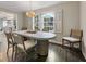 Dining room features hardwood floors, windows with shutters, and a view into the kitchen at 4243 Mcclatchey Ne Cir, Atlanta, GA 30342