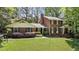 Charming brick home featuring a well-manicured lawn and mature landscaping at 4243 Mcclatchey Ne Cir, Atlanta, GA 30342
