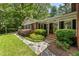 Beautiful brick home with black shutters, stone walkway, and manicured lawn at 4243 Mcclatchey Ne Cir, Atlanta, GA 30342