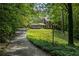 A long driveway leads up to a traditional brick home surrounded by lush greenery at 4243 Mcclatchey Ne Cir, Atlanta, GA 30342