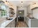 Charming kitchen features wood-look floors, white cabinets, open shelving, and stainless steel appliances at 4243 Mcclatchey Ne Cir, Atlanta, GA 30342