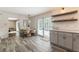 Kitchen featuring white cabinets and open shelves, adjacent dining area at 4243 Mcclatchey Ne Cir, Atlanta, GA 30342
