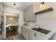 Galley kitchen features stainless appliances, white cabinets, and hardwood-look floors at 4243 Mcclatchey Ne Cir, Atlanta, GA 30342