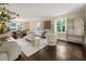 Bright living room features hardwood floors, neutral walls, modern decor, and many windows to let in natural light at 4243 Mcclatchey Ne Cir, Atlanta, GA 30342