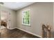 Inviting office space featuring hardwood floors and bright natural light from a large window at 4243 Mcclatchey Ne Cir, Atlanta, GA 30342