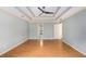 Light-filled main bedroom features hardwood floors, tray ceilings, and an ensuite bathroom at 106 Waterford Place Pl, Acworth, GA 30101