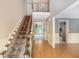 Bright foyer with hardwood floors, a carpeted staircase, and views into the home's living spaces at 106 Waterford Place Pl, Acworth, GA 30101