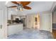 Kitchen shows stainless steel appliances, tile flooring, white cabinets and connection to the dining room at 106 Waterford Place Pl, Acworth, GA 30101
