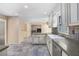 Kitchen features tile floors, white cabinets, large countertop and opens to the living room at 106 Waterford Place Pl, Acworth, GA 30101