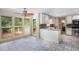 Bright kitchen boasts white cabinetry, stainless steel appliances, large windows and deck access at 106 Waterford Place Pl, Acworth, GA 30101