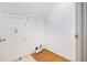 Compact laundry room with a wire shelf and hardwood floors, ready for customization at 106 Waterford Place Pl, Acworth, GA 30101