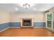 Spacious living room featuring a cozy fireplace, hardwood floors, and large windows at 106 Waterford Place Pl, Acworth, GA 30101