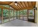 Inviting screened porch with wood ceiling, offering views of the lush backyard at 106 Waterford Place Pl, Acworth, GA 30101