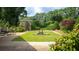 Lush backyard features a pergola, fire pit, and ample greenery at 110 Amsterdam Dr, Lilburn, GA 30047